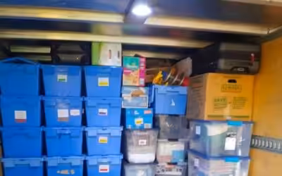 Stacked blue storage bins in truck