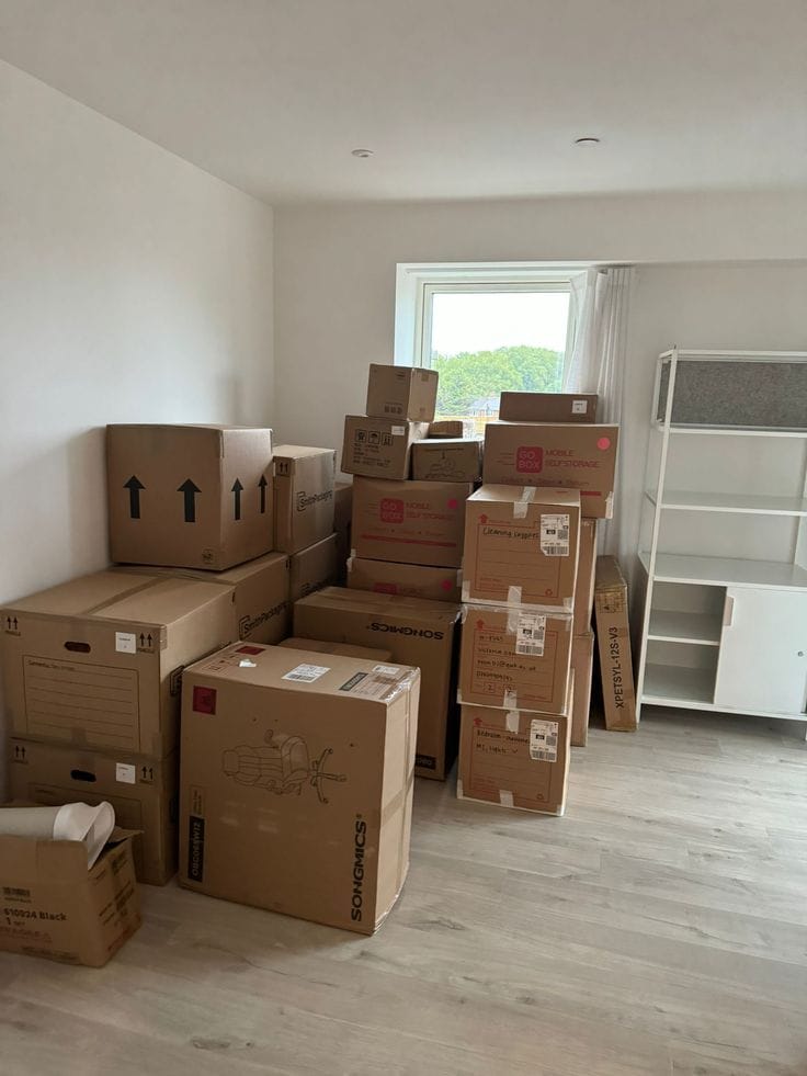 North York Movers Stacked moving boxes in empty room