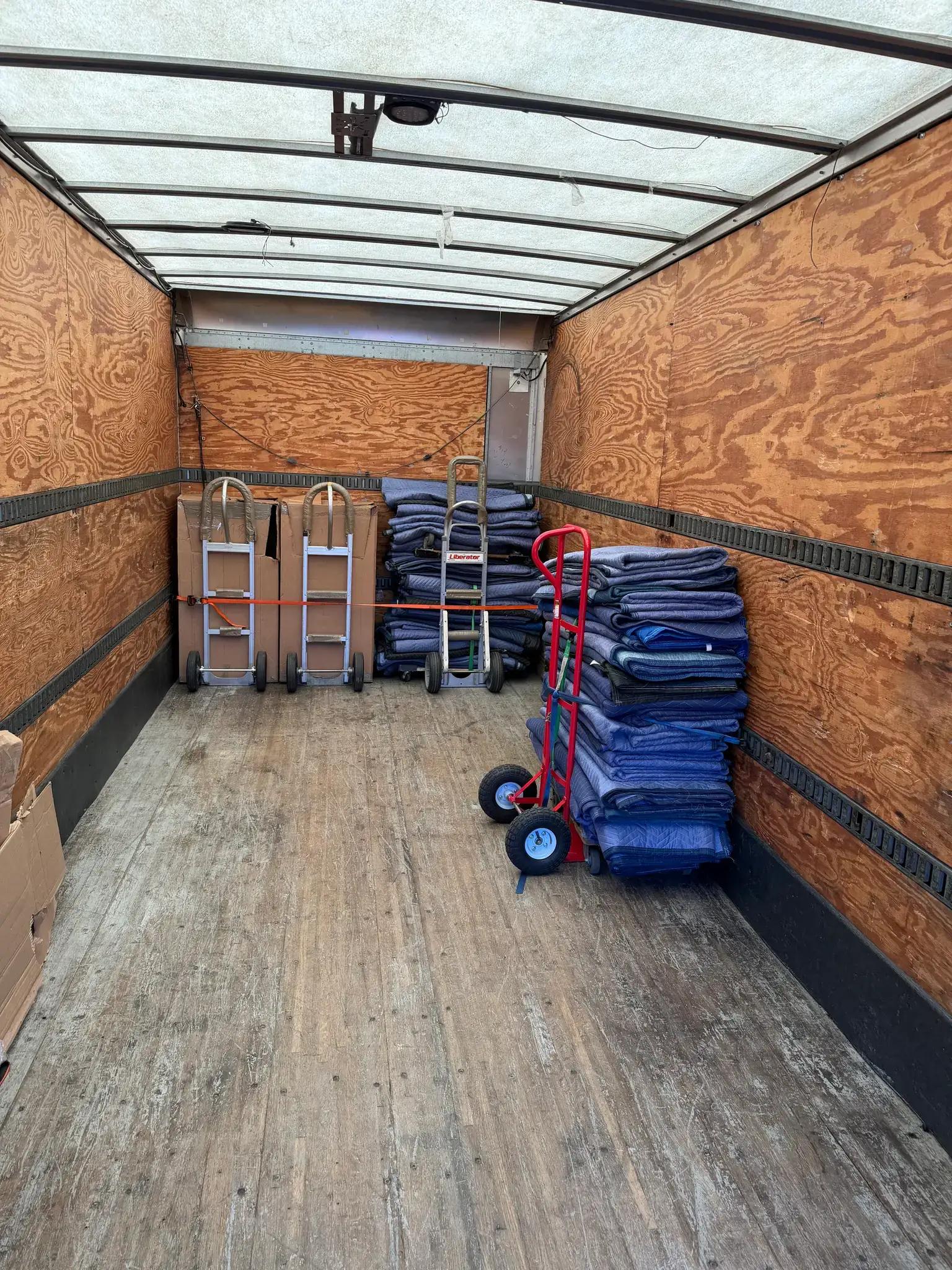 Commercial Movers Empty truck with moving equipment stacked